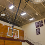 Basketball backstop with safety strap