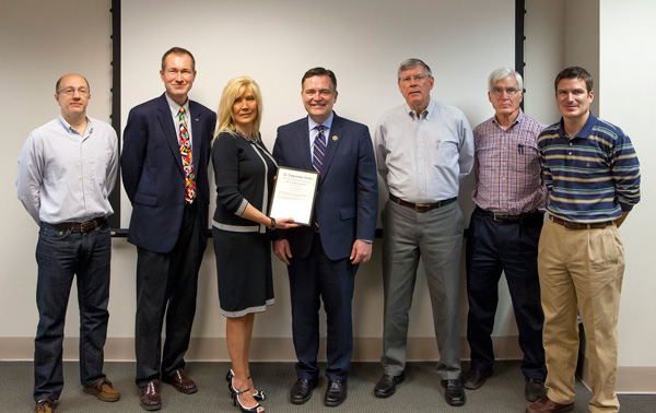 Rep. Luke Messer presents a copy of his remarks in the Congressional Record to Linda Brinson, Draper’s Safety and Wellness Director. Others in the photograph, from left to right – Draper salesperson Todd Hiday. Todd worked on Rep. Messer’s first campaign for Congress in 2000. Draper International Regional Manager Nate LaMar. Nate is the President of the Henry County Council. Draper owners John Pidgeon, Mike Broome and Chris Broome.
