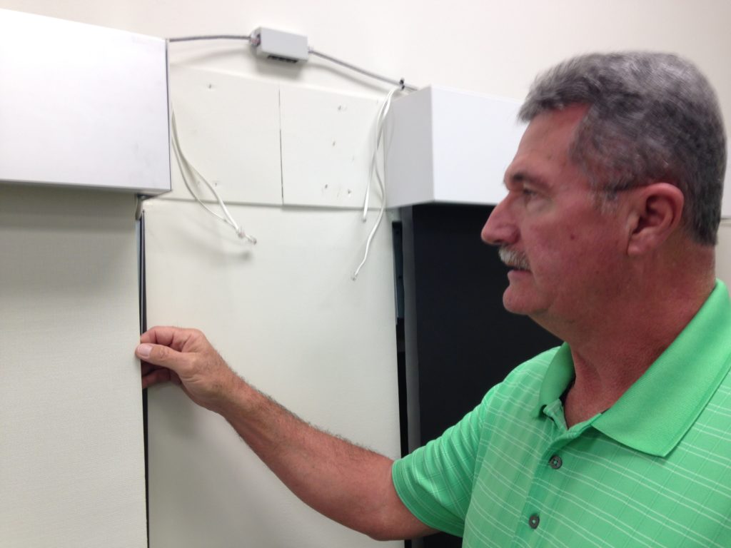 Jerry checks out a shade in the Heck Conference Room, which is used for training.